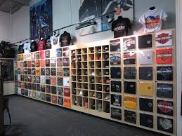 Brilliant The T Shirts Are Behind The Little Doors On Which The T Shirt Art Work Is Displayed Great Space Saver Store Interiors Shirt Display Store Displays