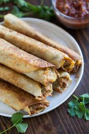 Burritos Filled With Refried Bean And Cheese Rolled Tightly And Pan Fried Until Crispy Stacked On Top Of Each Ot Bean And Cheese Burrito Burritos Recipe Food