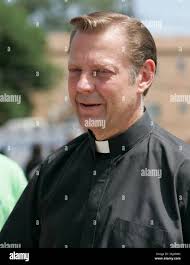 Priest with gun hi-res stock photography and images