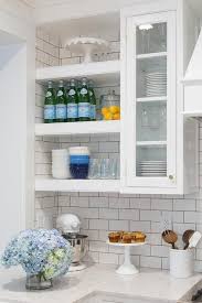 White Floating Shelves Are Mounted Beside Glass Front Cabinets Positioned Over A White And Glass Shelves Kitchen New Kitchen Cabinets Floating Shelves Kitchen