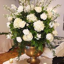 All White Bar Arrangement Accented With Lemon Leaf Italian Ruscus Curly Willow In Our Gold Agra Urn Mississippiweddin White Urn White Bar Italian Ruscus
