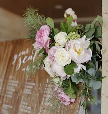 wood wedding signage seating chart with pink and white