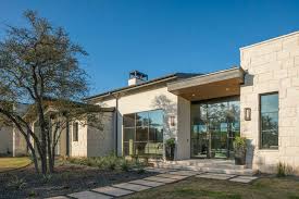 This ranch style house on lake buchanan is surrounded by lush gardens that use very little water. Hill Country Modern Vanguard Studio Architect Austin Texas