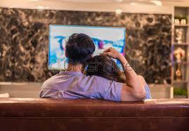 'because let's face it, no matter how much we would all love to lie on the sofa & feel sorry for ourselves on our lady days. Lovers Looking At Each Other While Watching Television On Sofa Stock Photo Crushpixel