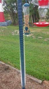 The slinky is capable of driving the squirrel back to the ground from where it came. Put Slinky On Pole To Keep Squirrels Away From Bird Feeder Bird Feeders Squirrel Proof Bird Feeders Bird Aviary