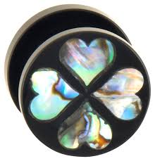 It has abalone shell, faux pearls, and white beads that are either glass or very hard plastic. Acrylic Plug With Abalone Shell Four Hearts Piercings