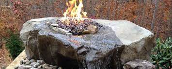 A seating area and dining set bring indoor comforts outside, while a fire pit and a fountain ensure a pleasant ambience any time of year. Firepit Fountain Boulder Fountain