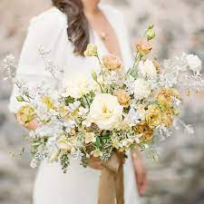 This gorgeous brides posy bouquet is made with realistic ivory roses with a diamante centre. Wild Organic Boho Pastel Wedding Bouquet Lisianthus Ranunculus Southwest Silk Ribbon Lindsey S Yellow Wedding Flowers Elegant Wedding Bouquets Wedding Bouquets