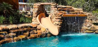 For traditional slides, you'll want to go with a rotomolded model, as these slides provide the best sliding surface and the most durability. Swimming Pool Rock Slides Photos Blue Haven Pools
