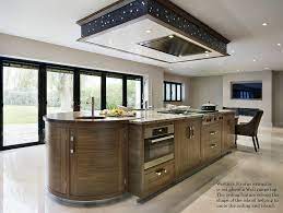 Often a ceiling feature is created in order to not only house the extractor but also to form a design feature in itself. Kitchen Extractor Fan Above Island
