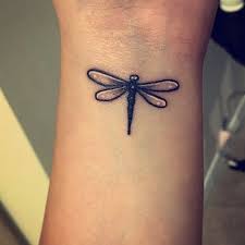 A small dragonfly tattoo that sits just to the side of the boob. My Lovely Dragonfly Tattoo Dragonflytattoo Ink Inkforwomen Insect Dragonfly Tattoo Tat Wrist Tattoos For Guys Dragonfly Tattoo Small Dragonfly Tattoo