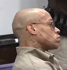 His face tells a life story. Look how the police looking at him. Young  kids, wake up and pay attention.