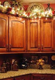 Garland and lights on top of the kitchen cabinets. The Vannaman Family Christmas Deco Christmas Kitchen Christmas Diy