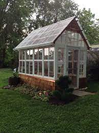 Laying out the windows to see how they would look before building was very important. This Is A 7 X12 Greenhouse I Made Out Of Old Windows From My Home I Used Poly Carbonate Plastic Roof Backyard Greenhouse Diy Greenhouse Plans Greenhouse Shed