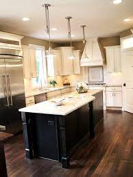 There are a lot of different materials you can use for your kitchen floors —from raw and original to glossy dark woods and painted colors, too. Dark Wood Floor Contemporary Kitchen Home Kitchens Kitchen Flooring