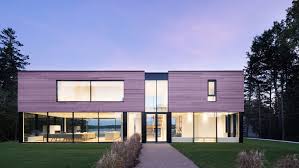 The home is a beacon high atop the hillside. Glass Surrounds Lower Level Of Teph Inlet House By Omar Gandhi Architect