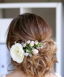 Messy Wedding Updo With A Big White Bloom And Some Smaller Ones Wedding Hair Flowers Romantic Wedding Hair Bride Hairstyles