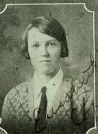 Mrs.Edna McElroy,52,of 1010 E.South Anita Ave.,Burbank,pulls collar of her  coat around her face as she hides behind purse at Burbank jail.She was one  of six persons picked up in a raid which