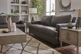 The plush modern channeled back cushions, and deep seat the sophisticated brown material is actually a polyester based fabric with the look of leather but has the warm feel of fabric. Hettinger Leather Sofa Ash Color 4950138 Hvl Electronics Furniture