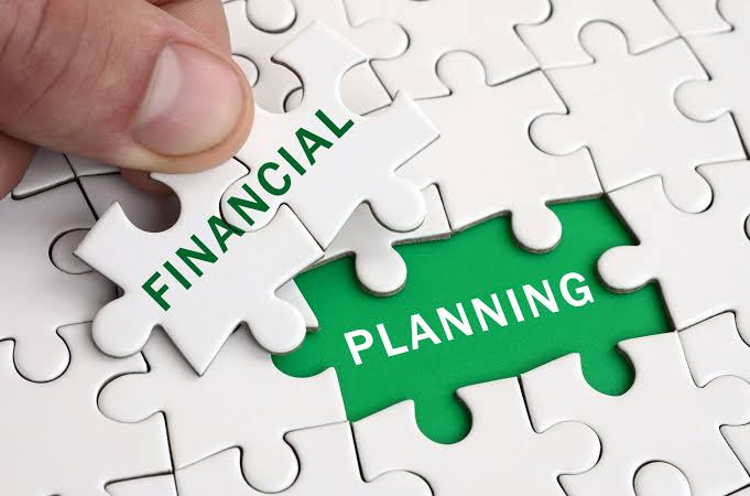 A collaborative business meeting where consultants discuss workforce strategy and financial planning with clients around a conference table. Documents, graphs, and budgeting reports highlight talent placement, taxadvisory, and a structured money management plan, showcasing expert business consulting and sustainable growth strategies.