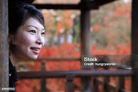 Woman In Autumn Park Stock Photo
