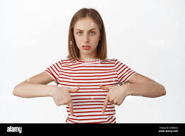 Frustrated blond girl pointing fingers down, furrow eyebrows and looking at  camera with concerned face, unsure about product banner, has doubts Stock  Photo - Alamy