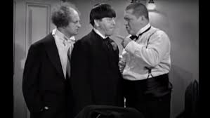 An entrant holds his curly moustache in place with sticky tape as he waits backstage (left) while other competitors help each other to some wore extraordinary costumes to match their extraordinary hair, with several candidates sporting hats to complete their unusual look. The Stooges Who Tried To Replace Curly