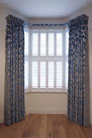 The use of roman, roller or bamboo curtains on the windows. Bespoke Triple Curtains With A Covered Lathe Fascia Integral Track Osborne Little Fabric Curtains Cool Curtains Curtain Styles