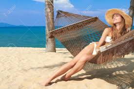 Sit and touch wood to open menu. Elegant Woman In A Bikini Reclining In A Hammock Strung Between Stock Photo Picture And Royalty Free Image Image 13346013