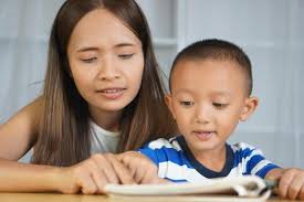 Mother teaching son to do homework 31609458 Stock Photo at Vecteezy