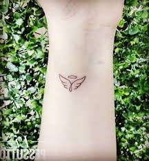 The initials, halo and the small angel wings create a spiritual tattoo piece on the. 1001 Ideas For A Beautiful And Meaningful Angel Wings Tattoo