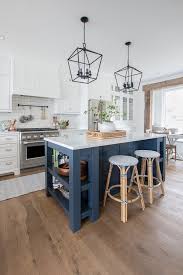 Another option for incorporating blue cabinets into the kitchen is to add them to your kitchen island. Navy Island White Kitchen The Lilypad Cottage