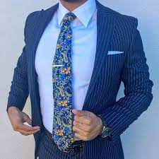 The navy suit is a staple in every discerning gentleman's wardrobe, and as a corollary, knowing which shirt and tie combinations complement a navy suit is of the utmost importance. Just Another Sophisticated Pinstripe Suit With An Elegant Floral Necktie Mens Suit Style Mens Fashion Suits Floral Tie