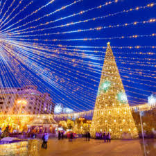 decorated tree and ornamental lights in Revolution Square of Bucharest in Romania - Travel Off Path