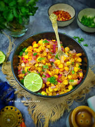 Corn Chaat Street Food with boiled corn, spices, lemon juice and herbs