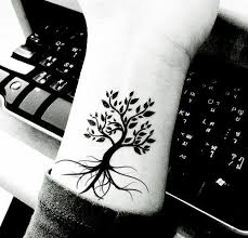 A woman with a gun and a tree tattoo on her arm. Pin On Tree Henna