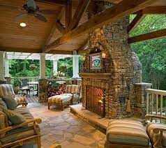 Outdoor sitting area with chairs, round table, fireplace with screen and stone design and seating area next to the pool. 53 Most Amazing Outdoor Fireplace Designs Ever
