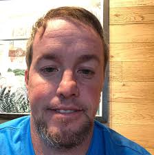 What bird species is the red bird at Sunset Park?