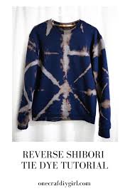 After you rinse the bleach out and the shirt is clean and damp, apply colored dye over the previously bleached areas. Reverse Tie Dye Sweatshirt Using The Shibori Method One Crafdiy Girl