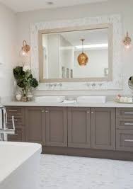 Loving The Two Tone Mix In This Bathroom The Hinkley Brushed Caramel Sconces Are A Nice Touch Taupe Bathroom Bathroom Cabinets Designs Transitional Bathroom