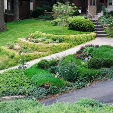 Tips For Taming A Slope Sloped Garden Garden Layout Small Backyard Gardens