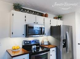 how to decorate above kitchen cabinets