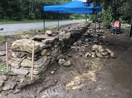 We had to redo our back retaining walls from an old wooden one to a new stone wall and install paver patios, redo our front old brick stairs to a new granite. Free Standing Stone Wall Sudbury Ma Concord Stoneworks