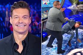 Ryan Seacrest Falls as 'Wheel of Fortune' Contestant Accidentally Knocks  Him Down