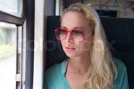 A woman enjoys nature traveling in a train