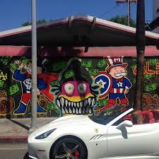 When we meet, monopoly is dressed all in black sporting long gold chains and a top hat, echoing his signature portrait of the mustached, tuxedoed. Chris Brown And Alec Monopoly Give L A Gas Station The Graffiti Touch Autoevolution