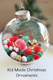 Kids decorating christmas tree with baubles in room — stock image & photo. Fill The Ball Kid Made Christmas Ornaments