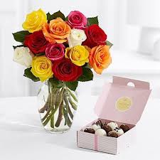 Basket arrangement of yellow flower like roses , gerberas and carnation along with celebration chocolate pack. Send Combo Of Chocolates And Flowers With Glass Vase Online Free Delivery Gift Jaipur