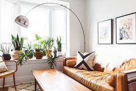 Bamboo with decorative planter artificial plant, green. 14 Plant Filled Living Rooms For Serious Decor Inspiration