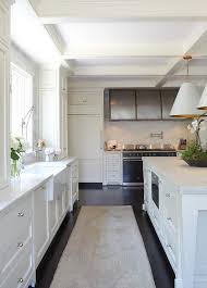 They can tie a design together, add a bright pop of color, or complement the landscape while offering additional storage space to the home. White Kitchen With Pink And Gray Faded Vintage Rug Transitional Kitchen